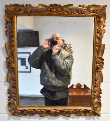 Lot 92 - A 20th century ornate gilt framed wall mirror,...