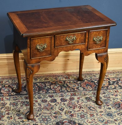 Lot 112 - A reproduction walnut lowboy.