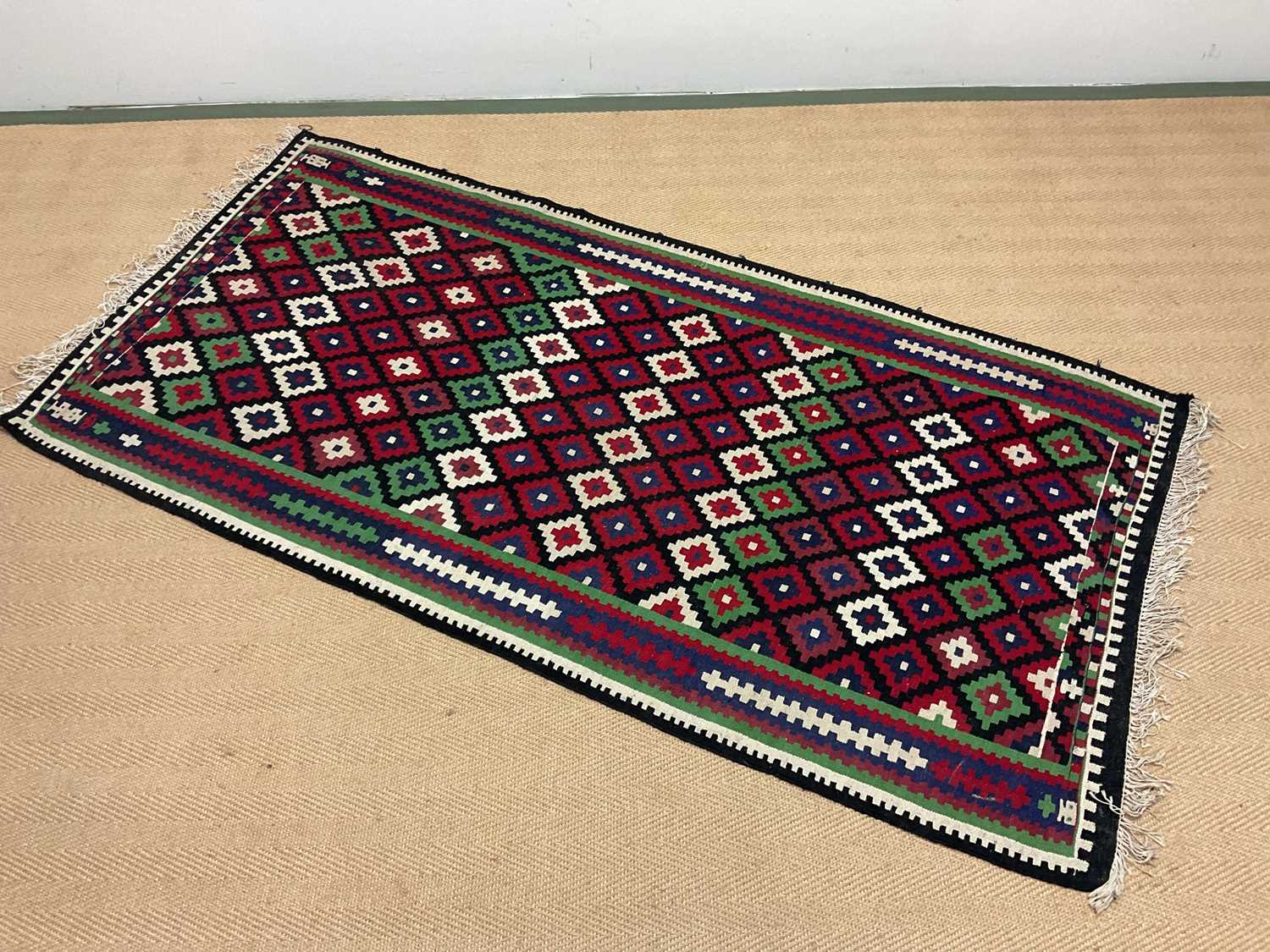 Lot 426 - A Kilim rug with geometric border and fringe,