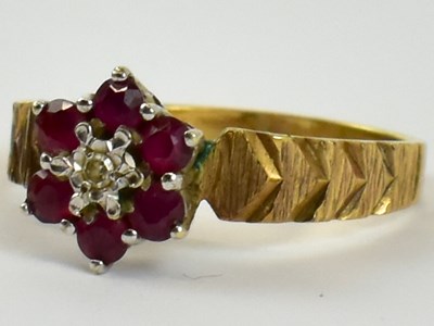 Lot 834 - A 9ct yellow gold ruby and diamond flower head...