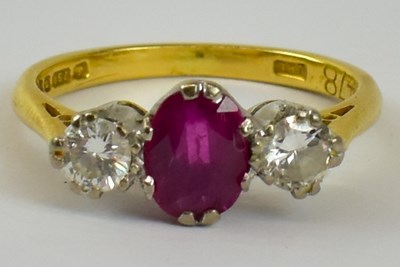 Lot 786 - An 18ct yellow gold three stone ruby and...