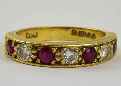 Lot 787 - An 18ct yellow gold diamond and ruby half...