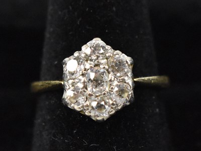 Lot 785 - An 18ct yellow gold diamond set flower head...