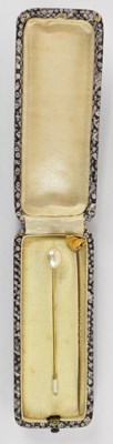 Lot 822 - A yellow metal tie pin with yellow metal rock...