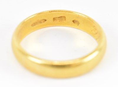 Lot 798 - A yellow metal wedding band, size R, approx 7.2g.