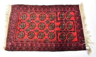 Lot 100 - A hand-knotted Turkoman Bokhara red ground rug,...