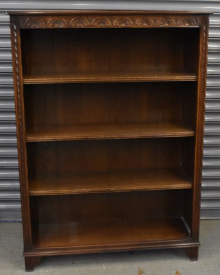 Lot 71 - A reproduction carved oak four shelf bookcase...