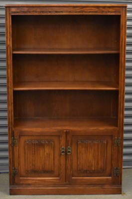 Lot 74 - A reproduction carved oak bookcase, with three...