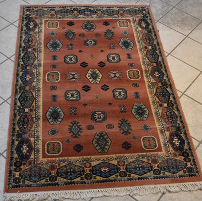 Lot 113 - A Persian red ground carpet with geometric...