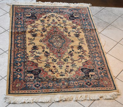 Lot 133 - A Persian red and cream ground carpet with...