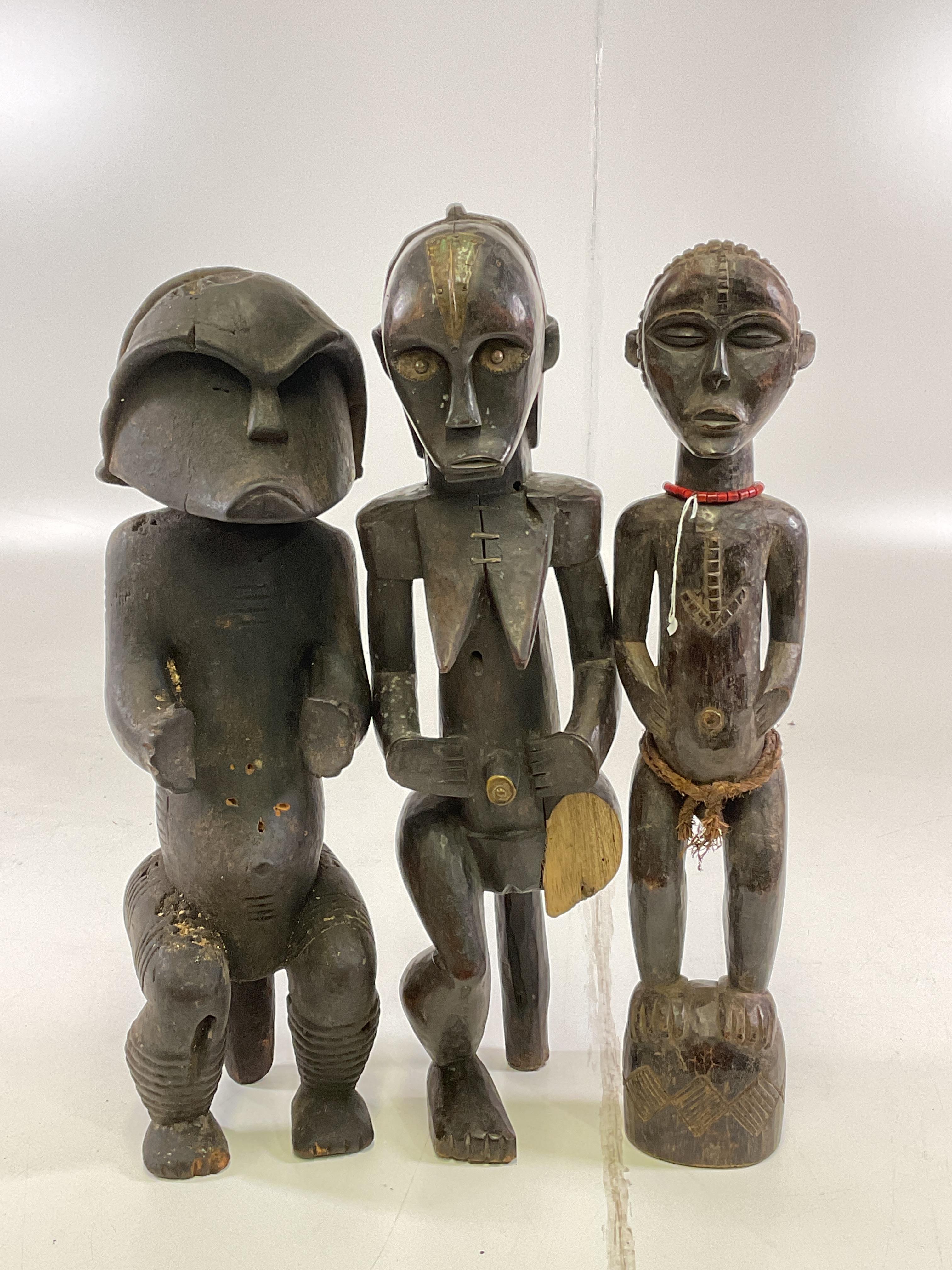 Lot 75 - Three African carved wooden tribal figures,