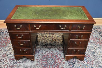 Lot 114 - A reproduction kneehole twin pedestal desk...