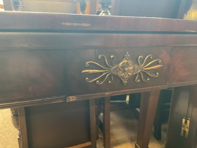 Lot 39 - A 19th century mahogany fold-over tea table...