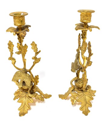 Lot 371 - A pair of gilt metal candlesticks in the form...