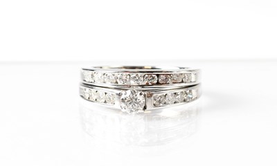 Lot 730 - An 18ct white gold wedding ring in the form of...