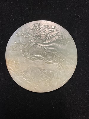 Lot 401 - A Chinese carved jade Bi disc, the front with...
