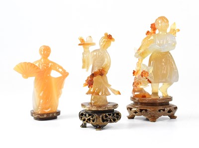 Lot 393 - Three Chinese carved quartz figures of females,...