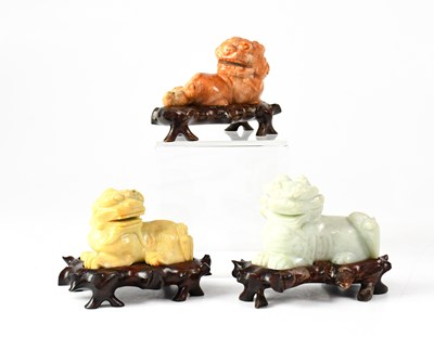 Lot 390 - Three Chinese carved coloured soapstone Chi...