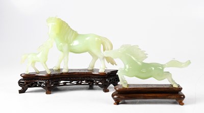 Lot 384 - A Chinese carved jade figure group of horse...