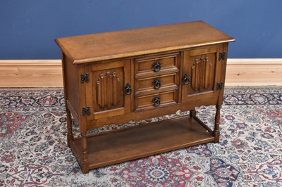 Lot 223 - A reproduction oak cupboard with two doors...