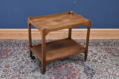 Lot 134 - A mahogany two tier trolley, length 76cm,...