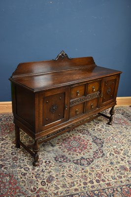 Lot 92 - A 1920s oak sideboard with raised back, with...