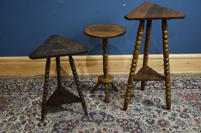 Lot 133 - Two oak occasional tables with triangular tops,...