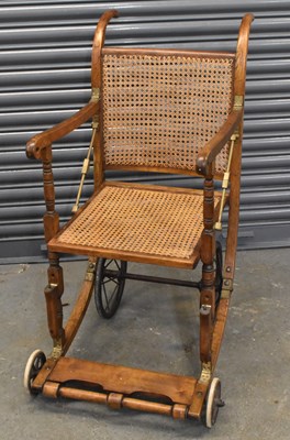 Lot 55 - An early 20th century cane seated invalid's...