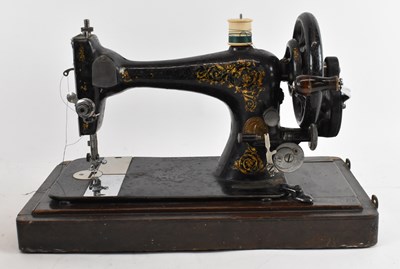 Lot 345 - A cased Singer sewing machine.