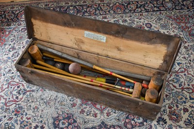 Lot 2392 - A vintage wooden cased croquet set.