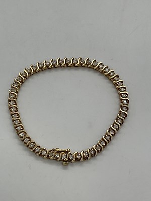 Lot 470 - A 14ct yellow gold and diamond line bracelet...