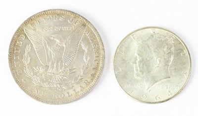 Lot 692 - An 1884 US silver dollar and a US 1964 half...
