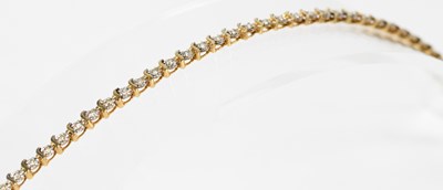 Lot 809 - A 9ct yellow gold tennis bracelet, length...