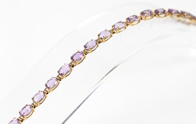 Lot 806 - A 9ct yellow gold bracelet set with oval...