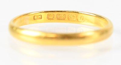 Lot 718 - A 22ct yellow gold wedding band, size P,...