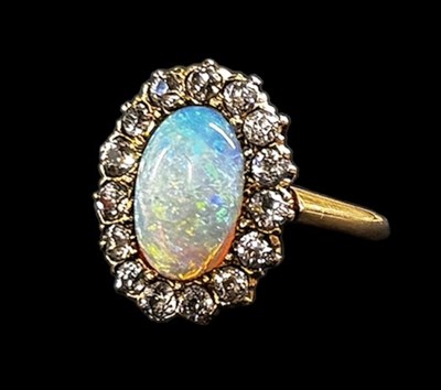 Lot 782 - A 14ct yellow gold opal and diamond ring, set...