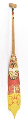 Lot 576 - A wooden tribal paddle with red, yellow and...