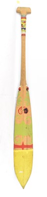 Lot 577 - An African wooden carved paddle with green,...