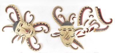 Lot 597 - A pair of wooden wall hanging masks with red,...