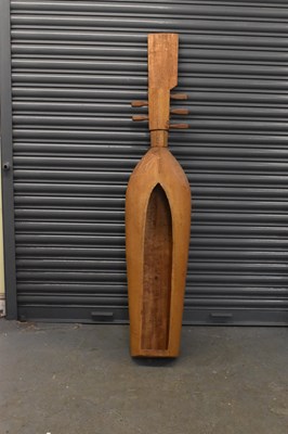 Lot 563 - A large carved tribal wooden sape with black...