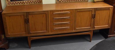 Lot 11 - A mid century teak sideboard with four central...