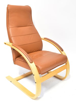 Lot 18 - A modern brown leather easy chair with beech...