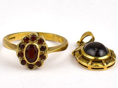 Lot 764 - A 9ct gold ruby cluster dress ring, size P,...