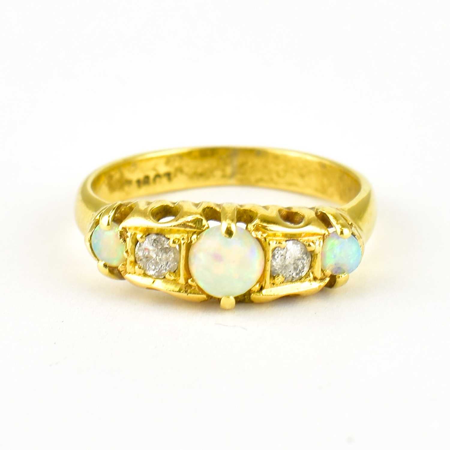 Lot 743 - An 18ct gold diamond and opal ring, size O,...