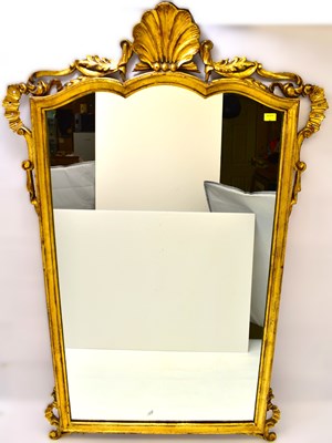 Lot 86 - A reproduction gilt framed wall mirror with...