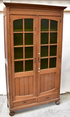 Lot 16 - An early 20th century oak two-door cabinet