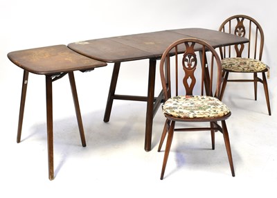 Lot 13 - ERCOL; a dark elm drop-leaf dining table with...