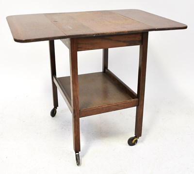 Lot 12 - ERCOL; a dark elm coffee table with undershelf,...
