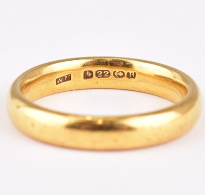 Lot 716 - A 22ct gold wedding band, size O, approx. 6.7g.