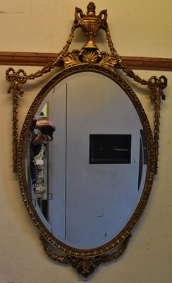 Lot 49 - A reproduction gilt framed wall mirror with...